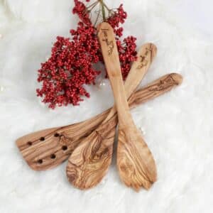 Handmade Wooden Kitchen Utensil Set: a wooden spork, a spatula with wholes and a large wooden cooking spoon