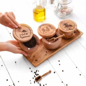 Wooden Spice Rack features three salt cellars, each with a pivoting lid and spice jar measuring spoon.