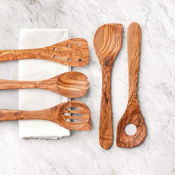 Olive Wood Kitchen Utensils Set: wooden cooking spatula, pierced spatula, spork and a slotted spatula.